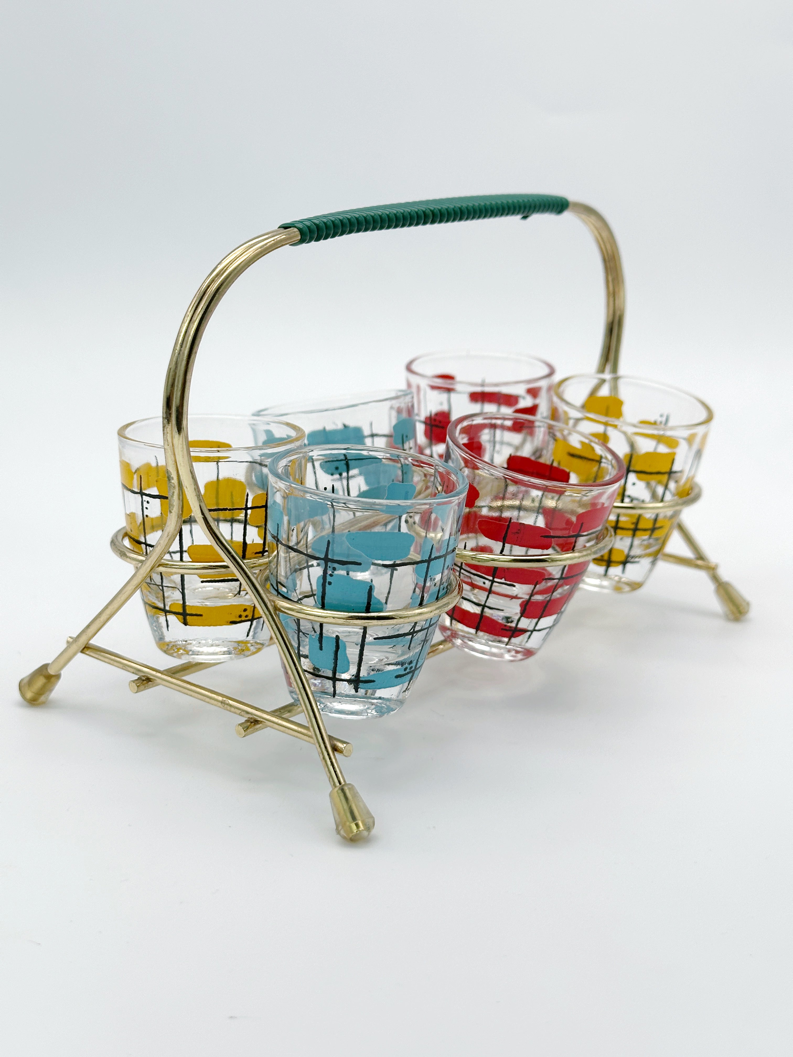Midcentury shot glasses in brass frame