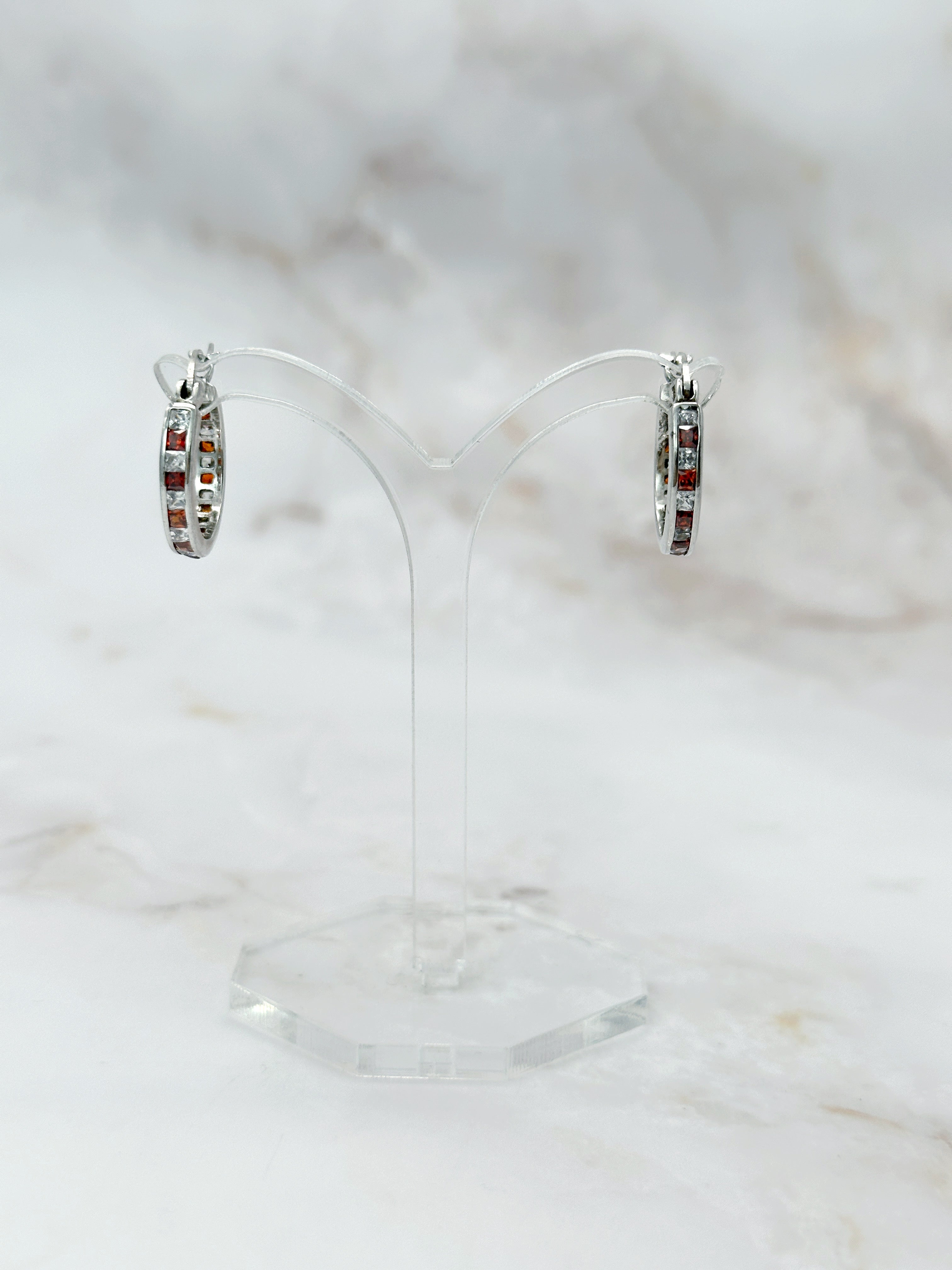Silver earrings with orange and clear rhinestones