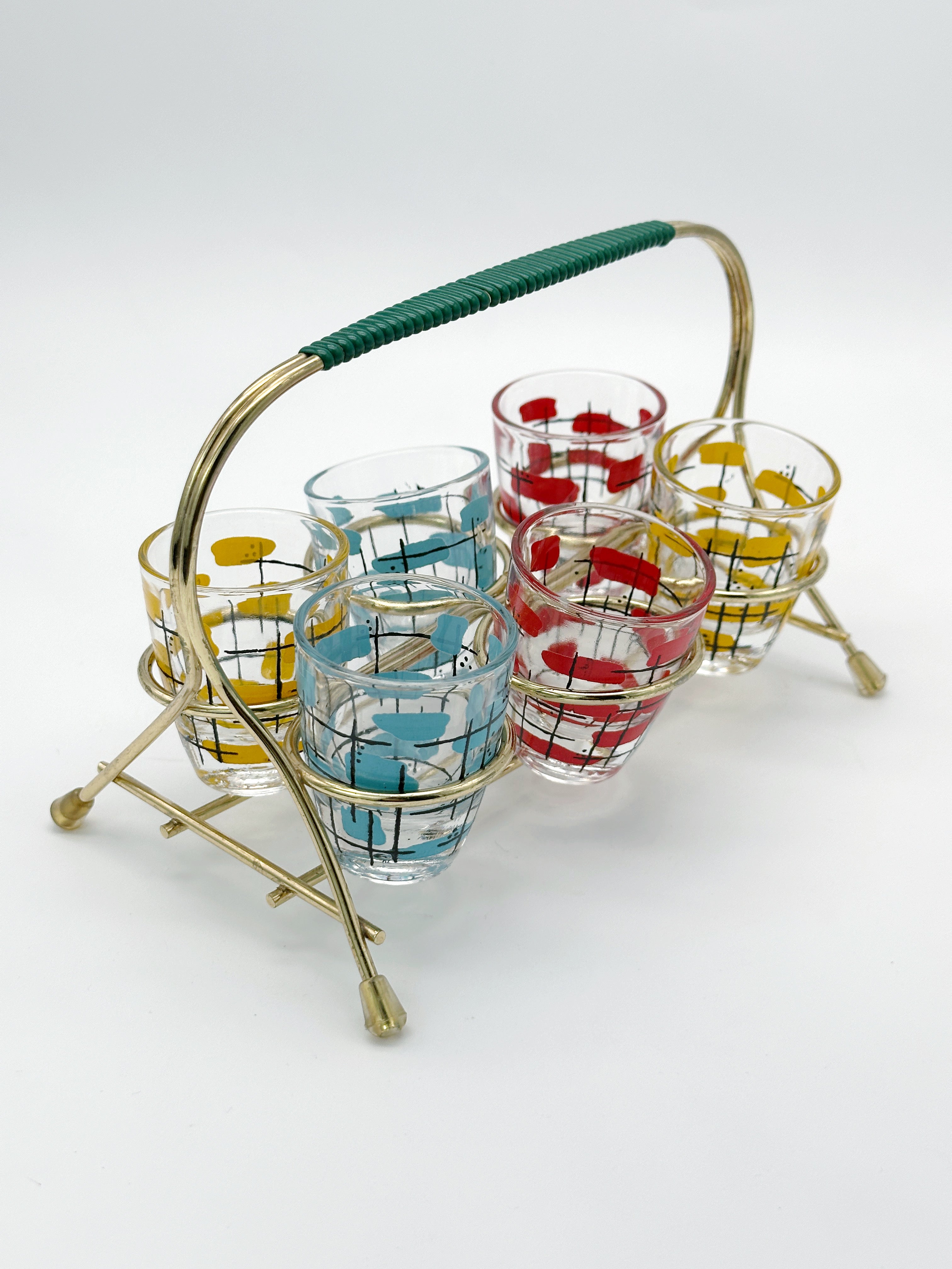 Midcentury shot glasses in brass frame