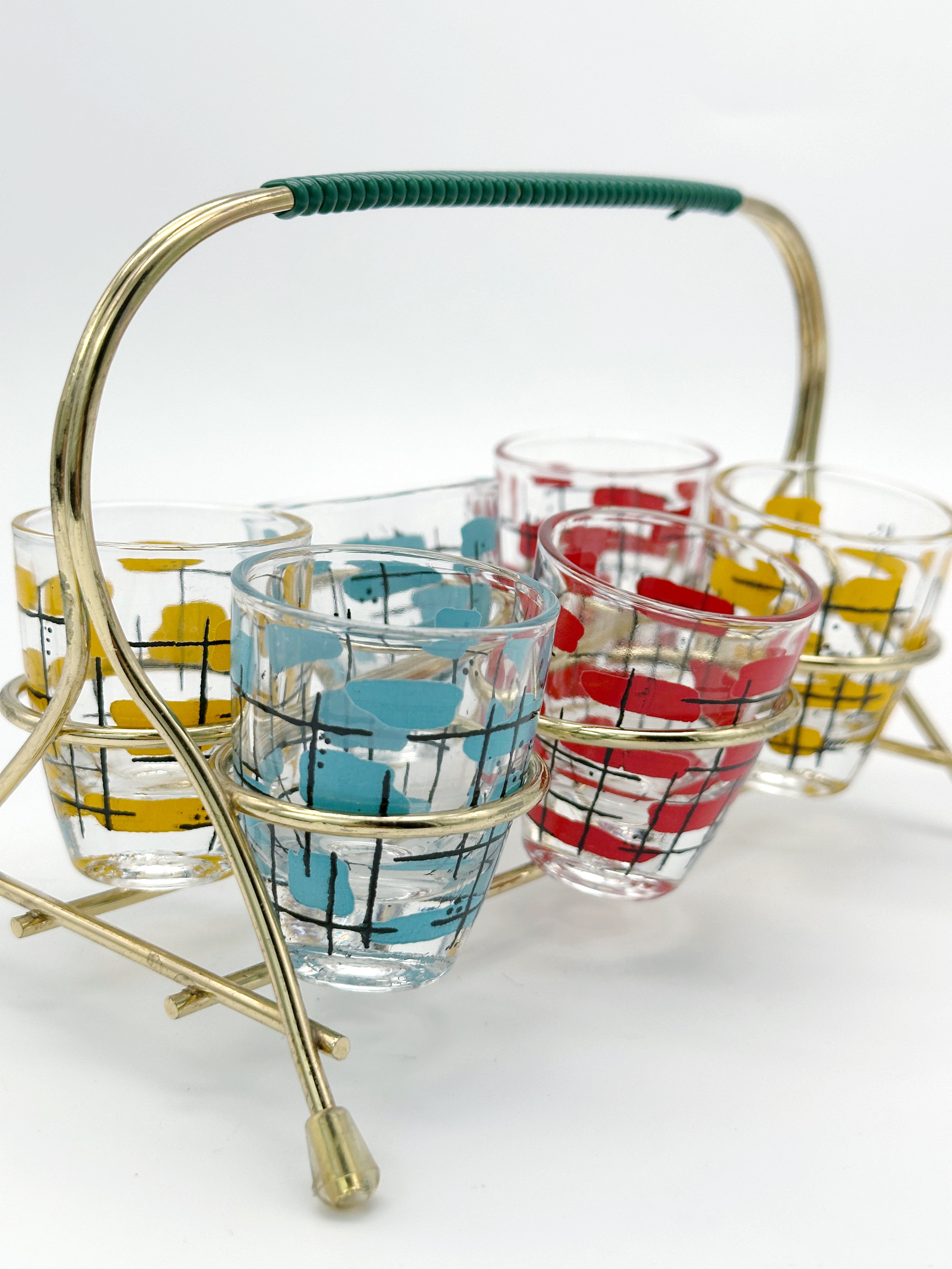 Midcentury shot glasses in brass frame